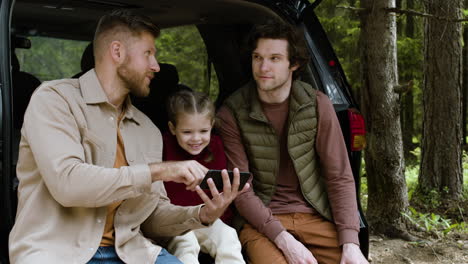 family watching video and taking backpacks