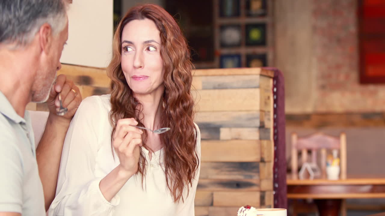 Happy couple eating cupcake together