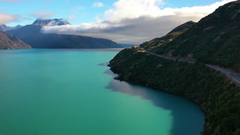 aerial drone view of a turquoise lake in the scenic wilderness of the southern alps mountains of new zealand