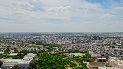 taj falaknuma palace with hyderabad city view, sky and clouds at engine bowli, falaknuma, hyderabad, telangana, india. day time, push in, drone shot. 4k