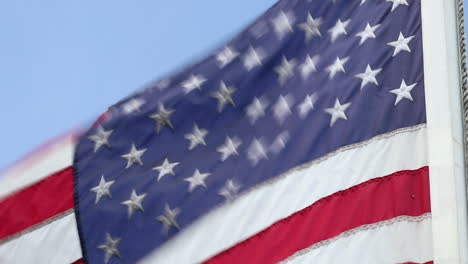 close up of american flag and blue sky