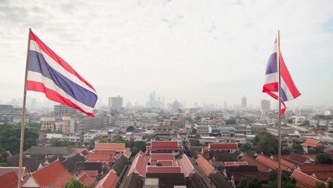 4k two thai state flags fluttering in the wind with bangkok at the background