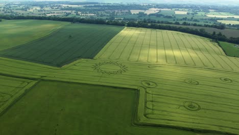 mysterious extraterrestrial ufo crop circle pattern on farmland, aerial drone view