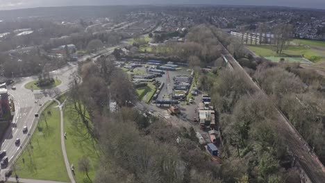 Slow-drone-shot-towards-house-narrow-boat-crane-at-repair-marina-UK