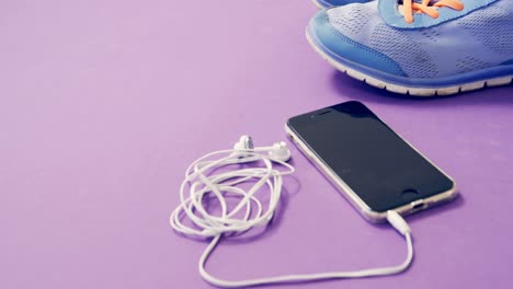 mobile phone with headphones and shoes