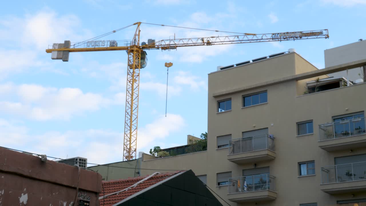 grúas de construcción que se elevan sobre apartamentos urbanos