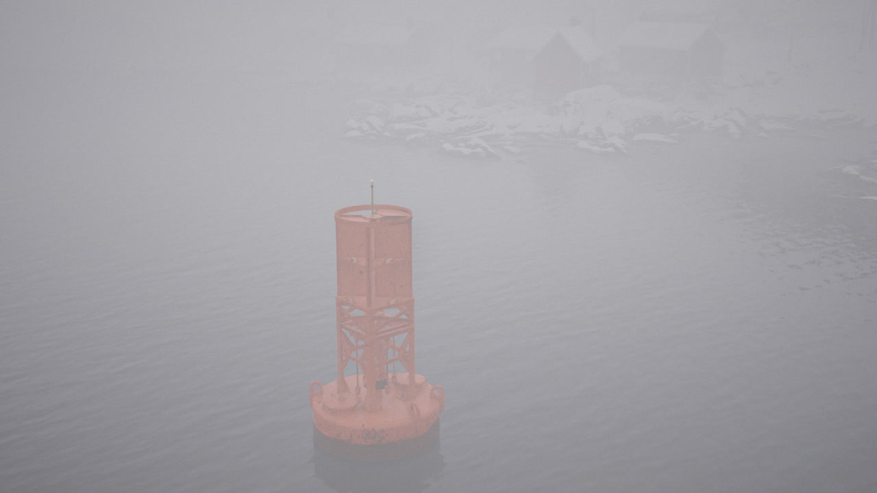 Buoy stands in foggy waters near icy landscape at dawn