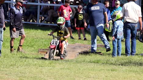 child motocross rider prepares and starts race