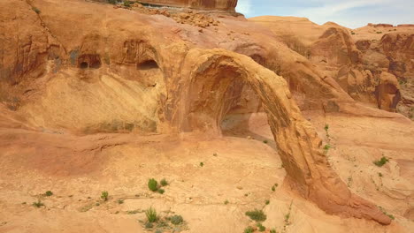 epic aerial pull back shot revealing the massive corona arch, a natural sandstone arch in utah