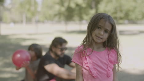 slow motion of cute caucasian girl standing in park