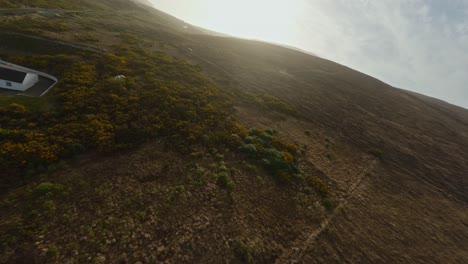 drones siguiendo pájaros volando sobre las colinas vacías en la isla de achill, irlanda