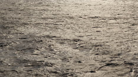 Wavy-open-sea-with-sun-reflecting-off-it-in-late-afternoon-from-mainland-Malta-to-Gozo