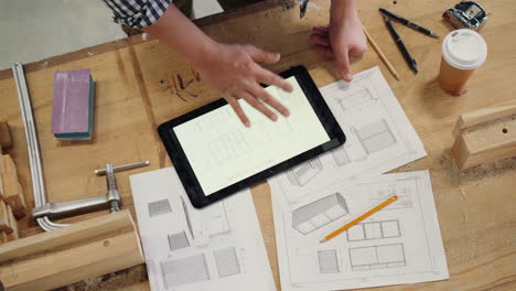 woodworker designing furniture on tablet