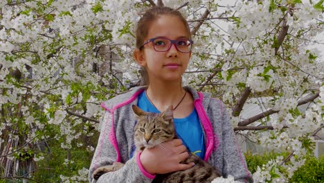 a little girl portrait against the background of a flowering cherry tree