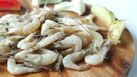 fresh shrimp on wooden board with vegetables