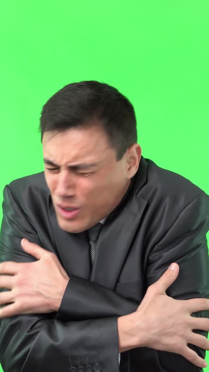 Man Shivering and Rubbing Hands on Green Screen