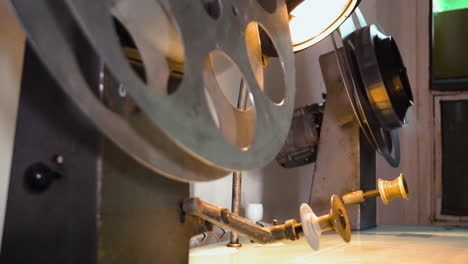 film reel coiled onto sloop with cinema machine over table