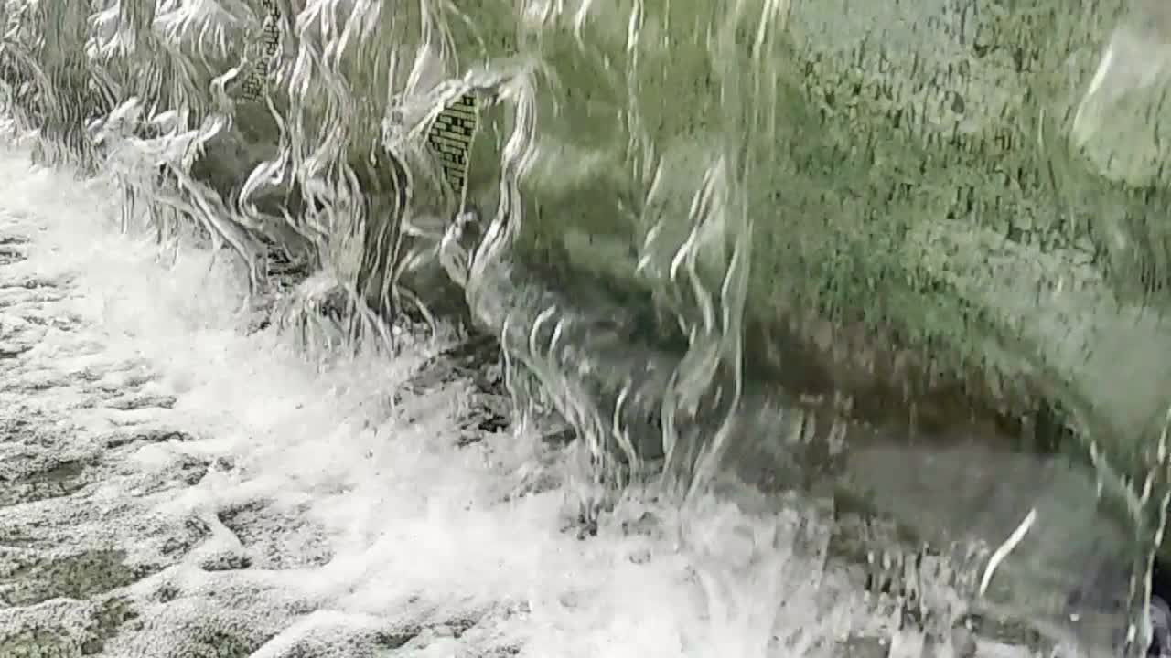 Close-up or fountain water drops to small pool in the city