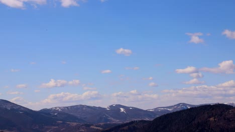 timelapse zoom into carpathian landscape with moving clouds over distant mountain peaks timelapse with zoomin showing a lush carpathian mountain landscape clouds drift across a blue daytime sky above distant peaks as the view gradually draws closer to the scene