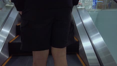 view-Camera-follows-a-man-going-up-an-escalator