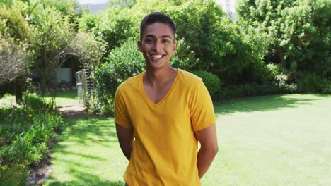 Portrait-of-mixed-race-man-smiling-to-camera-in-sunny-garden