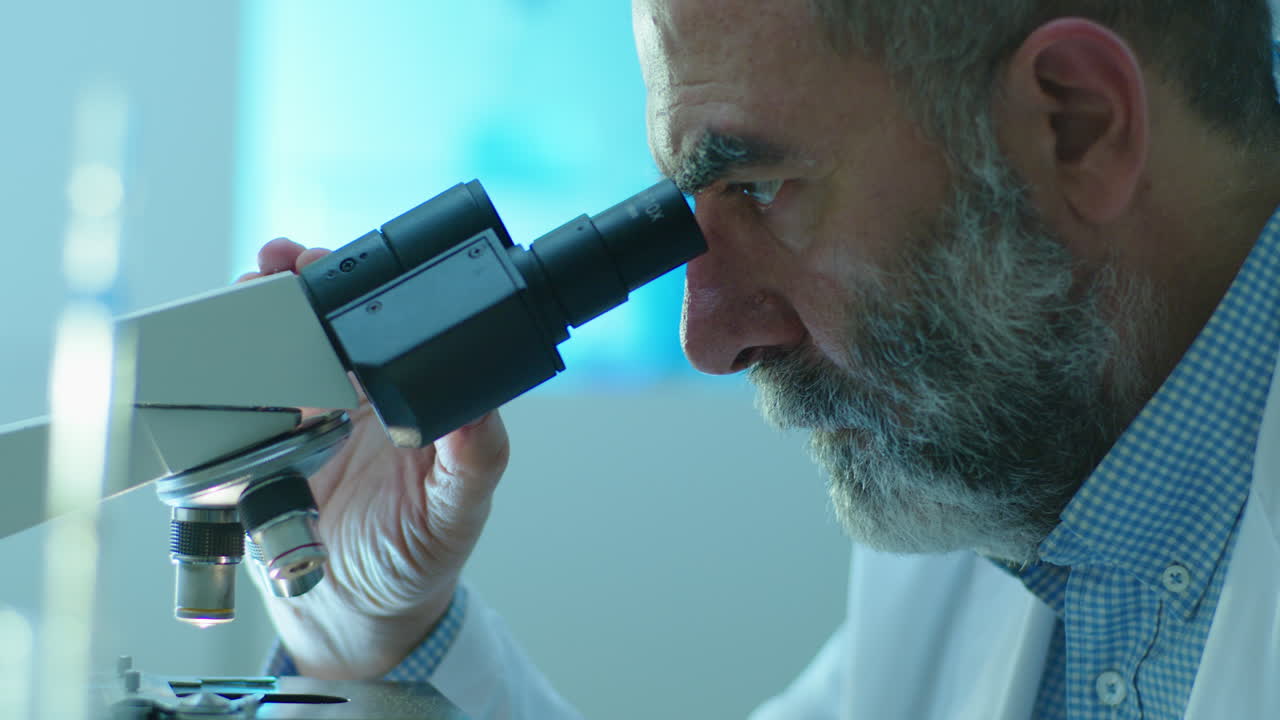 Scientist using a microscope