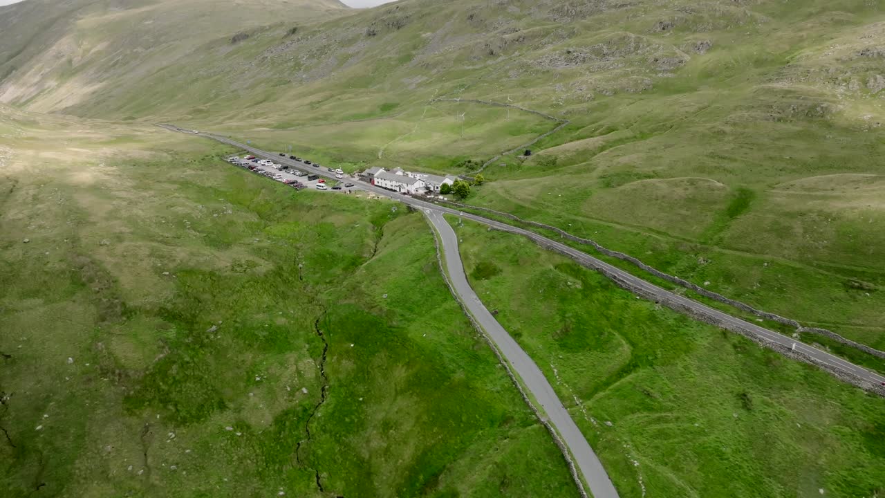 A592 And The Struggle Meeting At the Summit Of The Kirkstone Pass With Kirkstone Pass Inn Visible. Summer. Lake District, Cumbria, UK