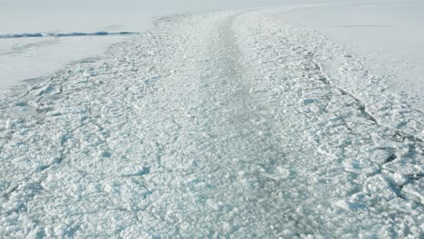 crushed ice shipping route created by icebreaker ship in the arctic, aerial