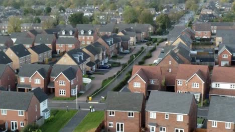 property ladder new british housing estate aerial view overlooking rooftops moving left