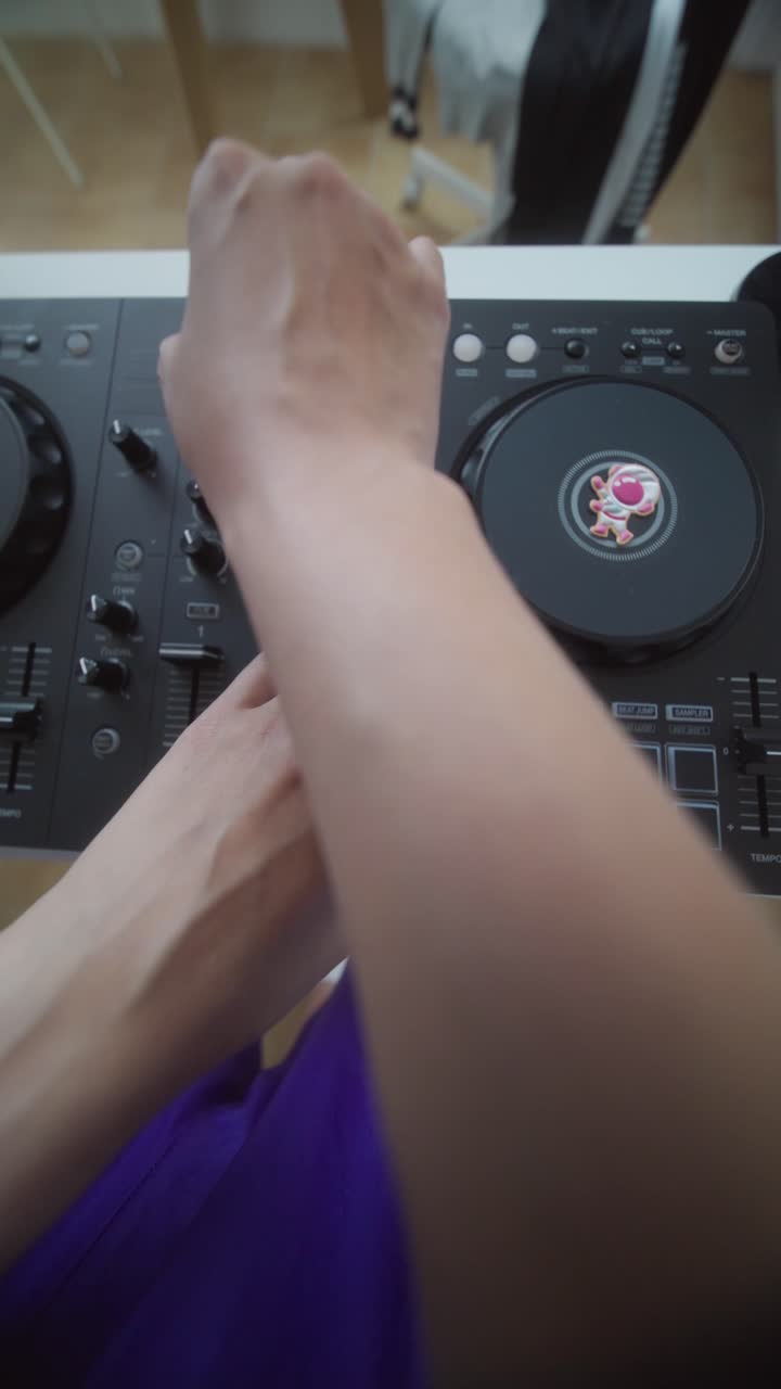 Top View of Hands Mixing Music on a DJ Controller