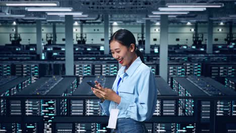 side view of asian business woman using mobile phone in data center