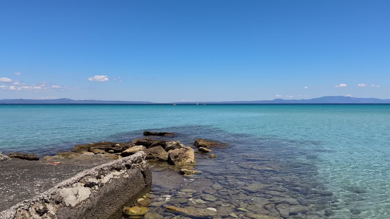 Stunning beach scene in Halkidiki, Greece, with elegant sunbeds facing the crystal-clear turquoise sea. A perfect summer escape in the heart of the Aegean.