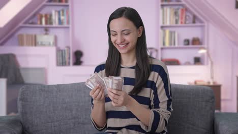 Happy-Indian-girl-counting-money