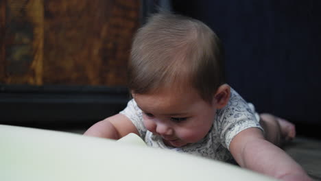 baby boy attempting to crawl on a play mat