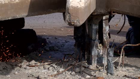 Handheld,-slow-motion-close-view-of-sparks-produced-by-a-welder-cutting-a-piece-of-steel-2