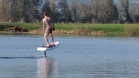 foilboard elevating above river waters europe in slow motion