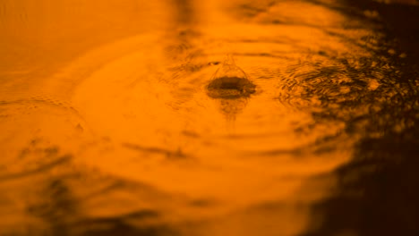 slow motion water rain droplet droping on water over ground, beautiful blue surface wave abstract wallpaper, pattern of circle on ground, splash from rain drop falling  and driping on wet floor