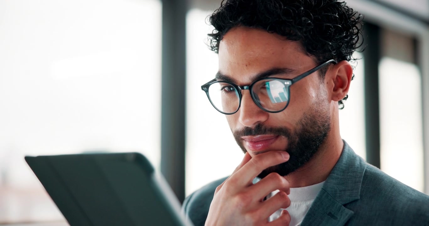Young Professional Man Using Tablet in Modern Office