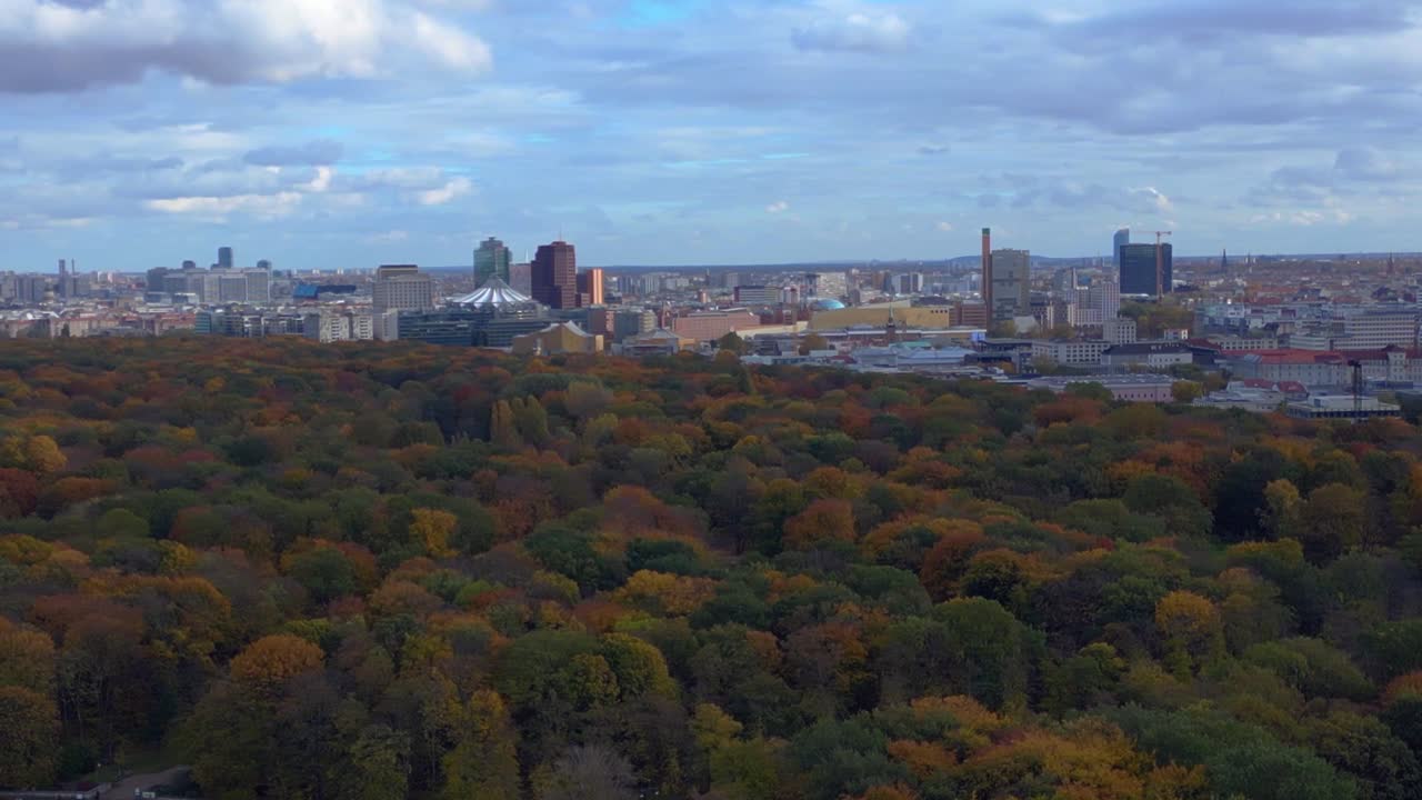 Aerial view discovering the vast Tiergarten park and Berlin cityscape during autumn. Great aerial view flight rotation pan to right panorama overview drone