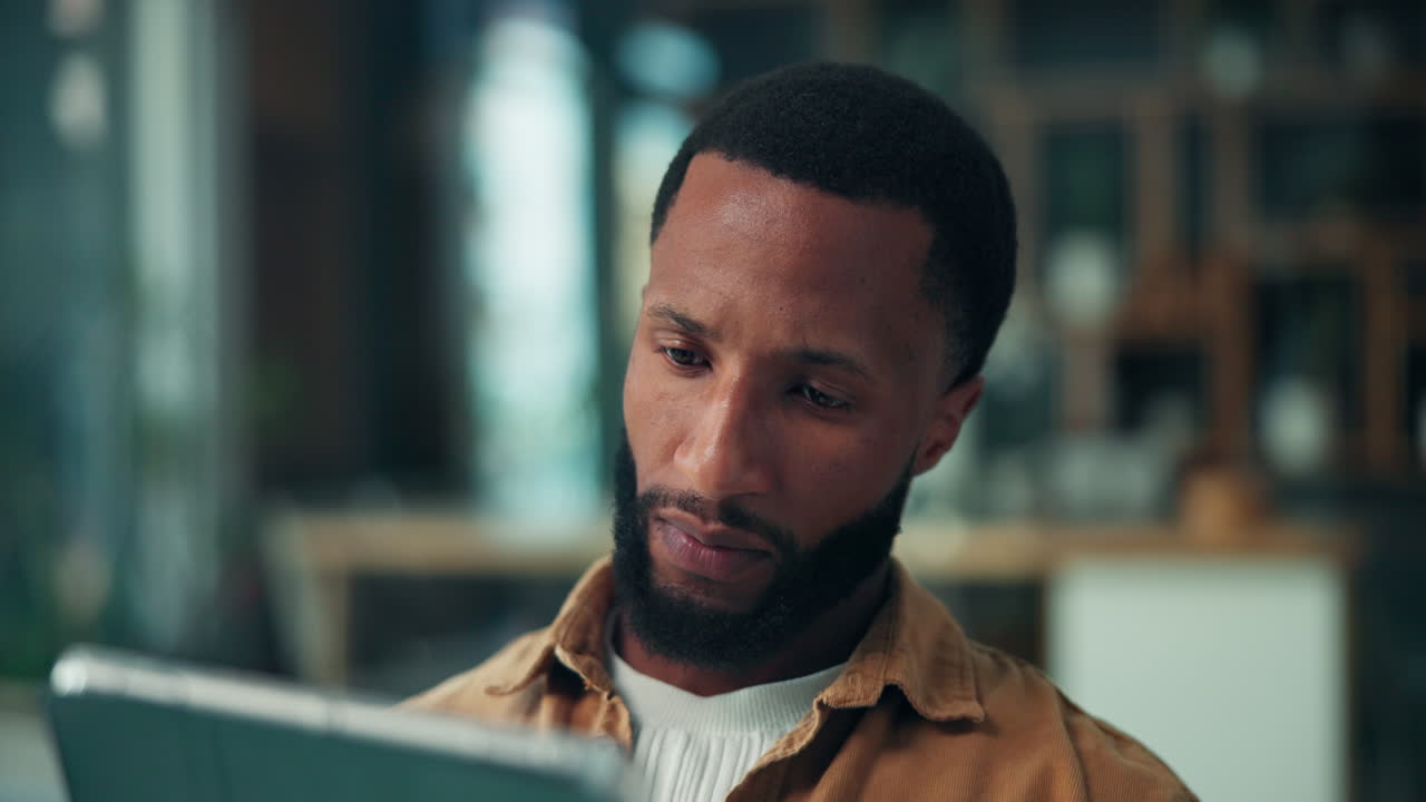 Man using a tablet and thinking