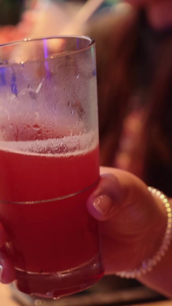 Persona con una bevanda rossa in un bar
