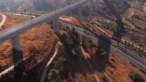 high-speed train bridge over a highway, aerial view