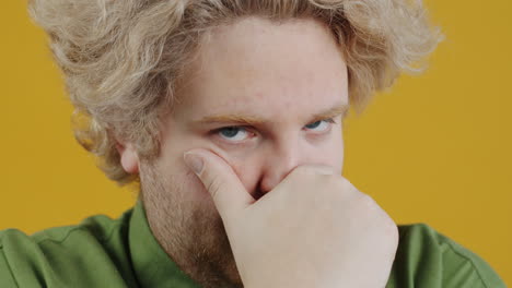 man with hand over face
