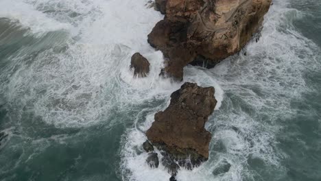 retroceso del promontorio de nazare que revela las olas del océano chocando contra las rocas, un famoso lugar de surf en portugal