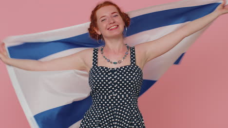 Happy-young-woman-in-dress-waving-and-wrapping-in-Israel-national-flag,-celebrating-Independence-day