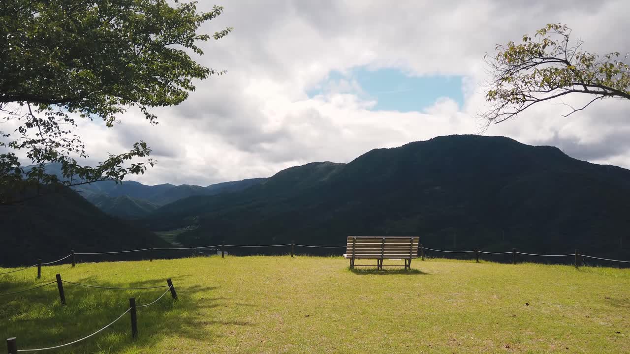 Relaxing bench landscape alone looking at Mountains of Japanese Valley in summer