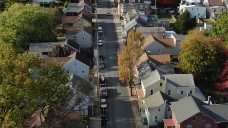 aerial tilt up reveals two story homes in small town community neighborhood