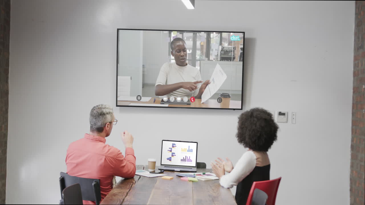 Diverse business people on video call with african american female colleague on screen