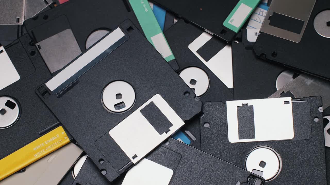 Using diskette for old computer. Music recorder, playing retro computer games. Vintage device for office, obsolete technology. . High quality 4k footage