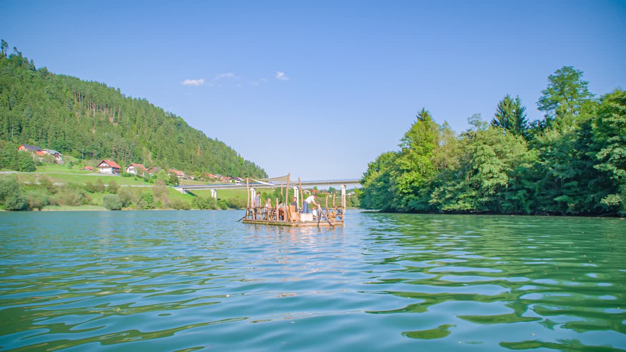 raftsman steer raft with oar, Drava river Hlodovc ride. Establishment shot